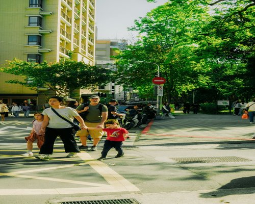 Family enjoying a calm neighbourhood walk on a sunny day